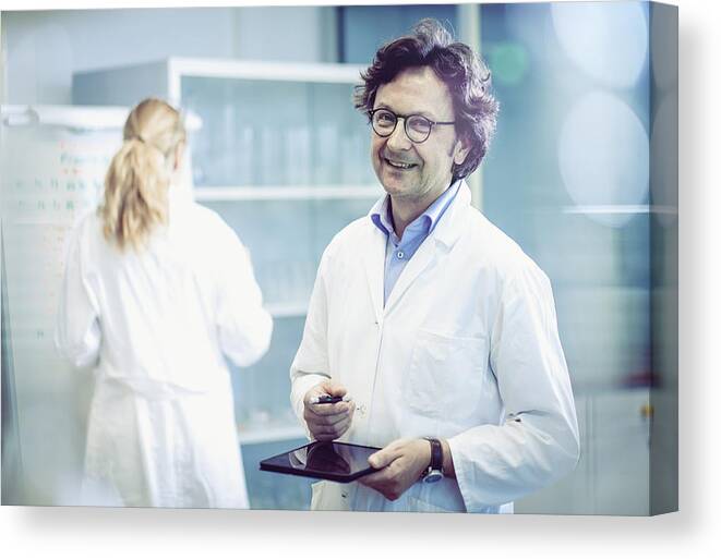 Working Canvas Print featuring the photograph Portrait of a Scientist in a Modern Laboratory by Sanjeri