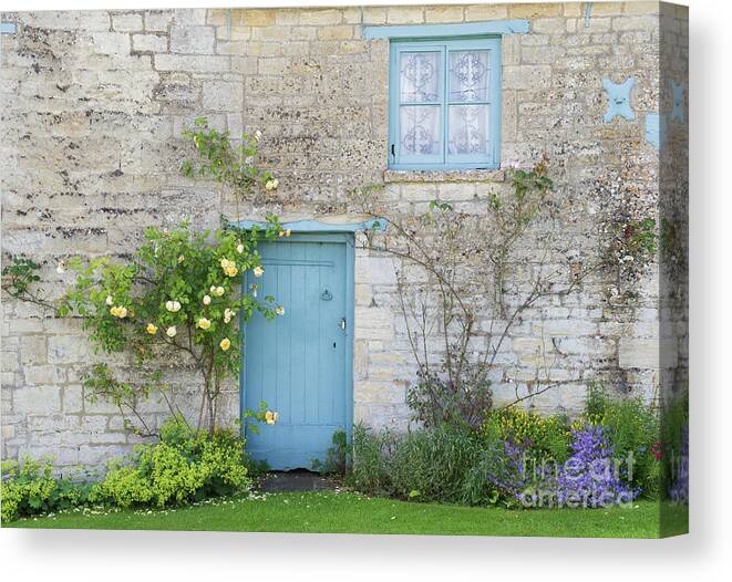 Windrush Canvas Print featuring the photograph Windrush village Cottage Door and Roses by Tim Gainey