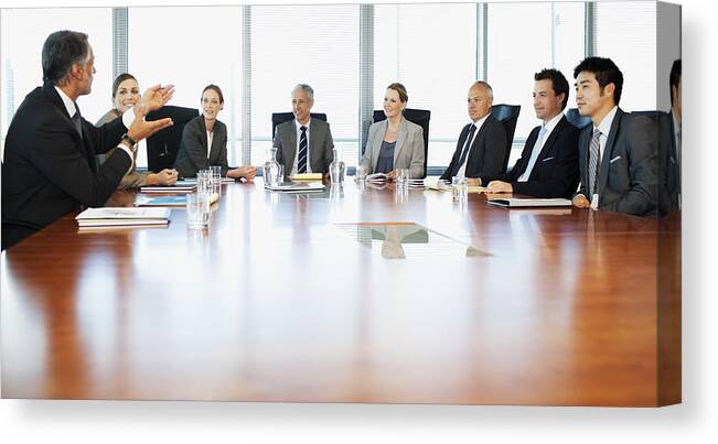 Working Canvas Print featuring the photograph Business people meeting at table in conference room by Robert Daly