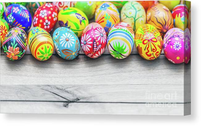 Easter Canvas Print featuring the photograph Easter handmade eggs on wooden table. #1 by Michal Bednarek
