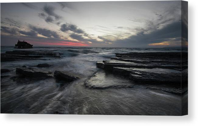 Seascape Canvas Print featuring the photograph Shipwreck of an abandoned ship on a rocky shore by Michalakis Ppalis