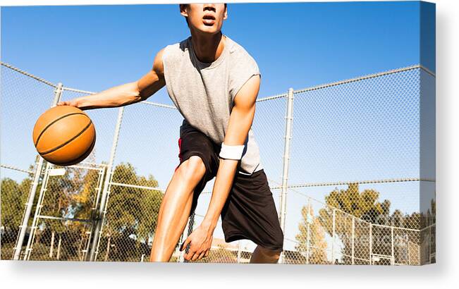 College Canvas Print featuring the photograph Fit Male Playing Basketball Outdoor by Pkpix
