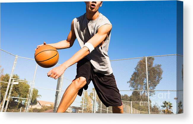 College Canvas Print featuring the photograph Handsome Male Playing Basketball Outdoor by Pkpix