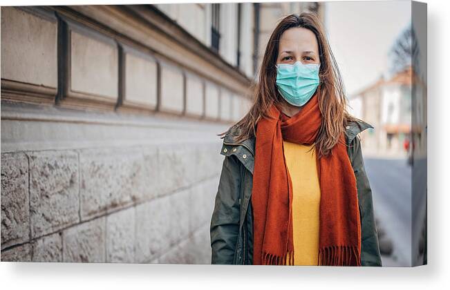 Lifestyles Canvas Print featuring the photograph Woman with protective mask on the street in city #2 by South_agency