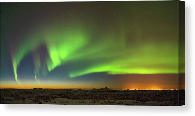 Iceland Canvas Print featuring the photograph Aurora above Keflavik in Iceland. by Andy Astbury