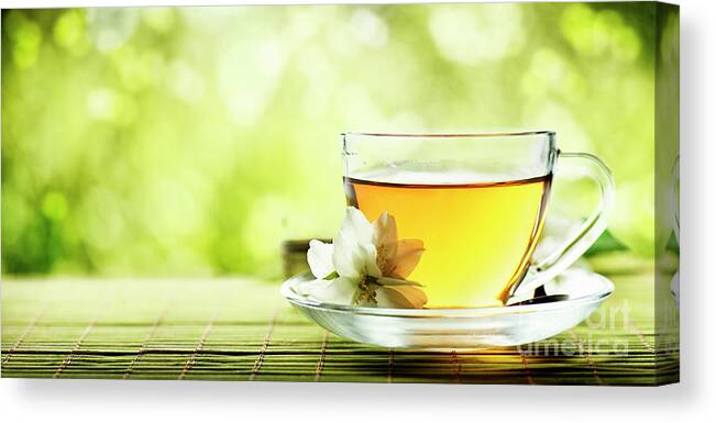 Tea Canvas Print featuring the photograph Herbal cup of tea on wooden table by Jelena Jovanovic