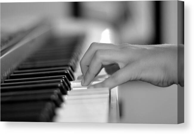 Playing Piano Canvas Print featuring the photograph Hand on piano keyboard by Serena King