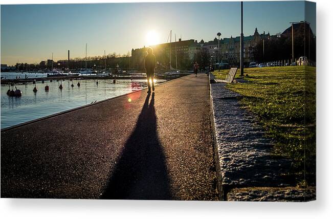 Man Walking At Sunset - Helsinki Canvas Print featuring the photograph Man walking at sunset - Helsinki, Finland - Color street photography by Giuseppe Milo