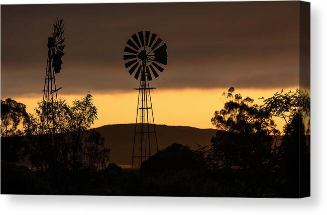 Windmill Canvas Print featuring the photograph Windmills at sunrise by Claudio Maioli