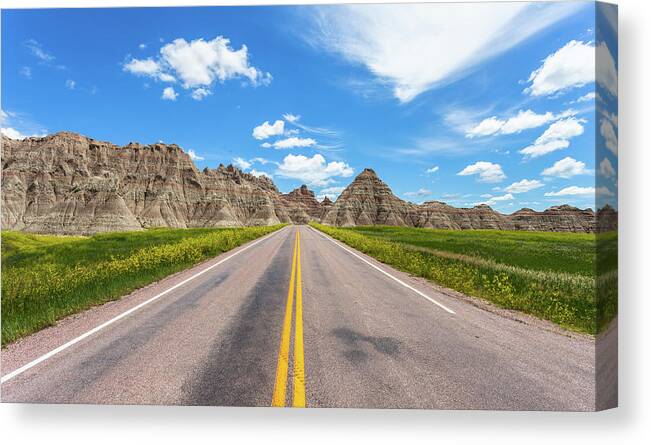 Badlands Canvas Print featuring the photograph The road less traveled by Chris Spencer