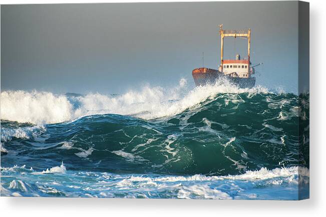 Shipwreck Canvas Print featuring the photograph Abandoned ship in the stormy ocean by Michalakis Ppalis