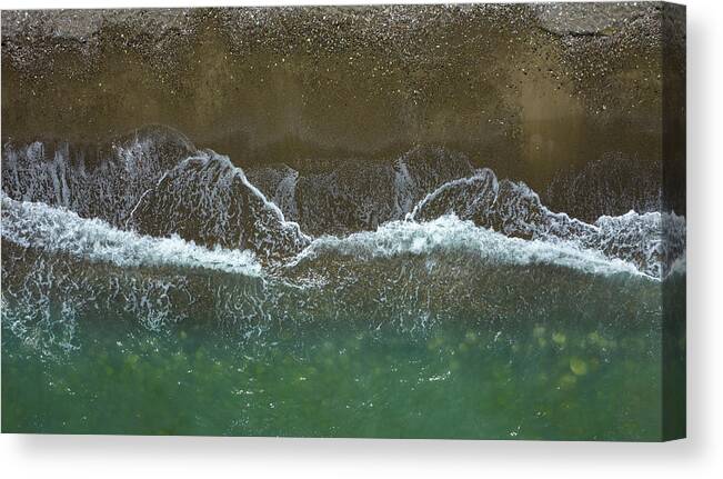 Waves Canvas Print featuring the photograph Aerial view ocean waves braking on a sandy beach. Nature background by Michalakis Ppalis