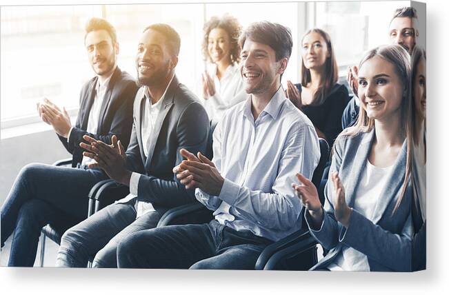 Speaker Canvas Print featuring the photograph Applauding to speaker. Group of happy business people in conference hall by Prostock-Studio