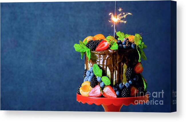 Birthday Canvas Print featuring the photograph Chocolate drip cake decorated with fresh fruit and berries with copy space. by Milleflore Images