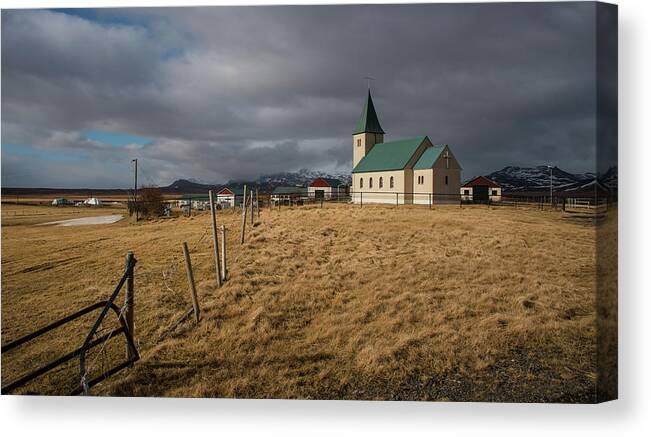 Icelandic Canvas Print featuring the photograph Icelandinc landscape with traditional church in Iceland by Michalakis Ppalis