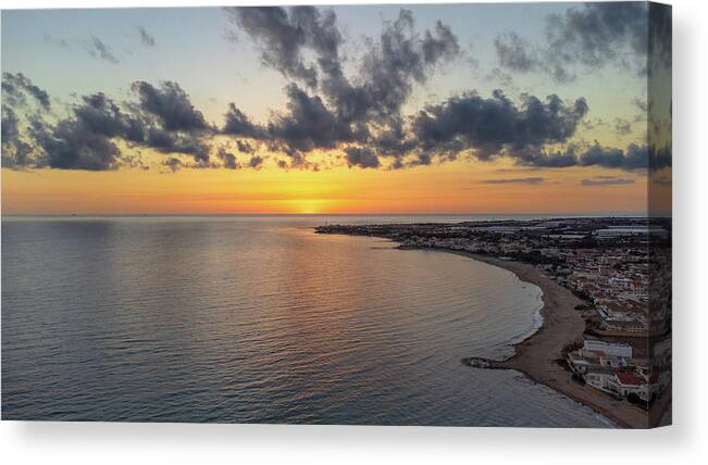 Aerial Canvas Print featuring the photograph Sunset over the sea by Mirko Chessari