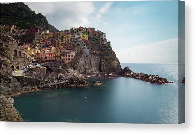 Cinque Terre Canvas Print featuring the photograph Village of Manarola with colourful houses at the edge of the cliff Riomaggiore, Cinque Terre, Liguria, Italy by Michalakis Ppalis