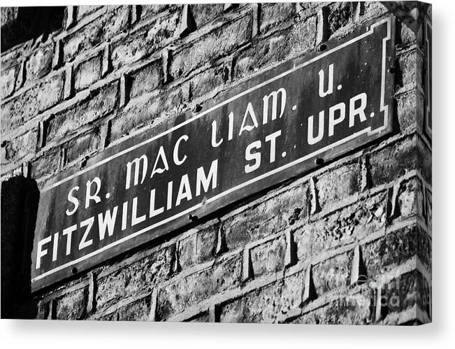 Dublin Canvas Print featuring the photograph Old Style Green And White Fitzwilliam Street Upper Sign In Irish And English In Dublin On Red Brick Wall by Joe Fox