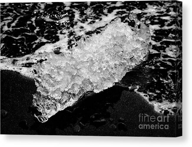 Ice Canvas Print featuring the photograph Ice washed up on black sand beach at jokulsarlon iceland #8 by Joe Fox