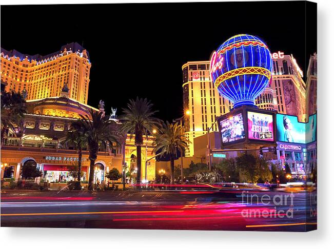 Motion On The Strip At Night Canvas Print featuring the photograph Motion on the Strip at Night by John Rizzuto
