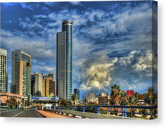 Israel Canvas Print featuring the photograph The Skyscraper And Low Clouds Dance by Ron Shoshani