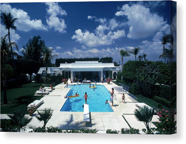 1980-1989 Canvas Print featuring the photograph Pool In Palm Beach by Slim Aarons