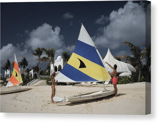Adjusting Canvas Print featuring the photograph Sailing In Anguilla by Slim Aarons