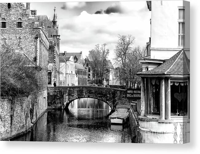 On The Canal Bridge In Bruges Canvas Print featuring the photograph On the Canal Bridge in Bruges by John Rizzuto