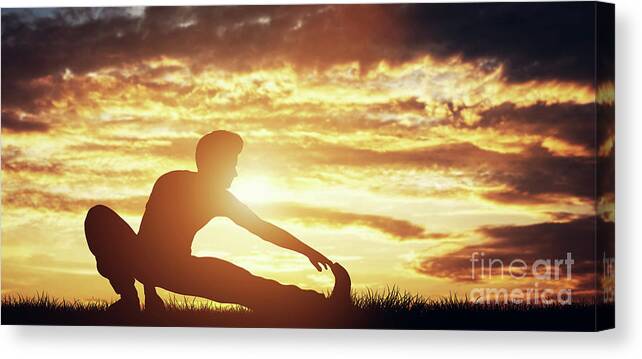 Man Canvas Print featuring the photograph Man stretching his body in the sunset. by Michal Bednarek