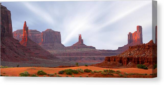 Desert Canvas Print featuring the photograph Monument Valley at Sunset Panoramic by Mike McGlothlen