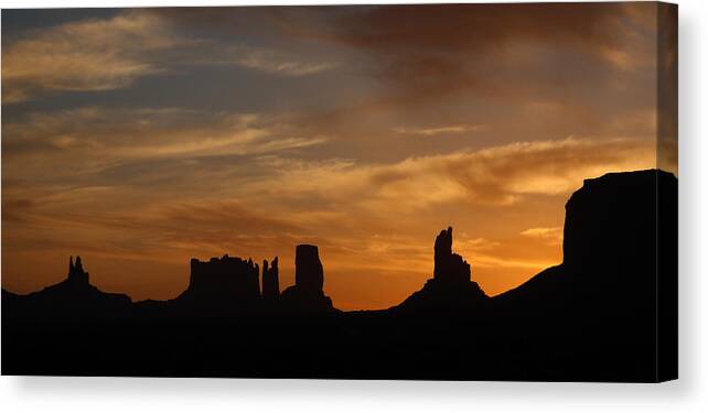 Sunrise Canvas Print featuring the photograph Early Sunrise over Monument Valley by Jean Clark