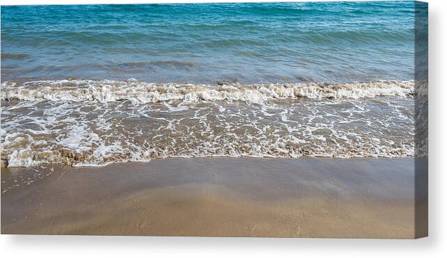 Abstract Canvas Print featuring the photograph Seashore wave with sandy beach background by Michalakis Ppalis