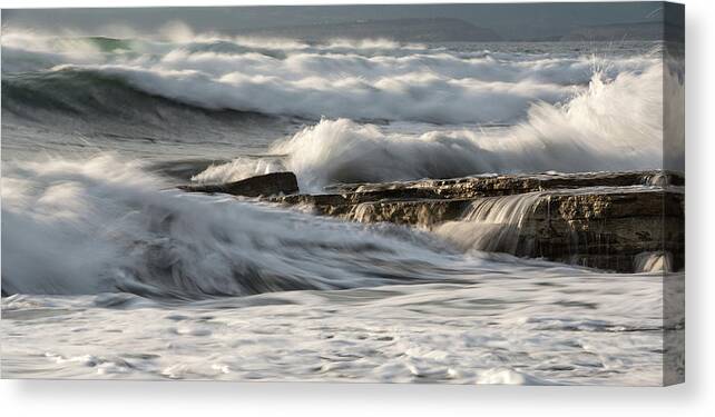 Seascape Canvas Print featuring the photograph Rocky seashore with wavy ocean and waves crashing on the rocks #5 by Michalakis Ppalis