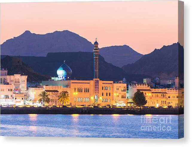 Oman Canvas Print featuring the photograph Oman - Muscat - Mutrah harbour and old town at dusk by Matteo Colombo