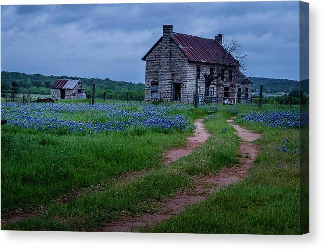 A Dirt Road Leads To A Charming 1800 Era Stone House In The Texas Hill Country As An Evening Storm Rolls In. Canvas Print featuring the photograph The Road Home by Johnny Boyd