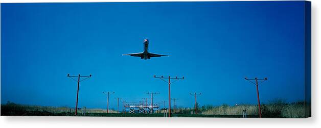 Photography Canvas Print featuring the photograph Airplane Landing Philadelphia by Panoramic Images