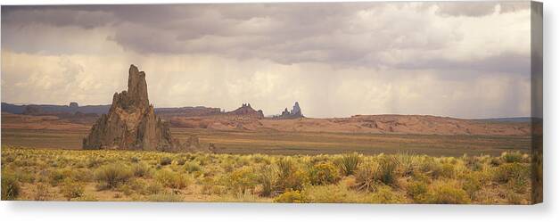 Panoramic Canvas Print featuring the photograph USA, Arizona, Church Rock, near Kayenta, rock formations and wild flowers by Timothy Hearsum