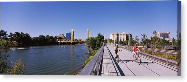 Photography Canvas Print featuring the photograph Bicyclists Along The Sacramento River by Panoramic Images