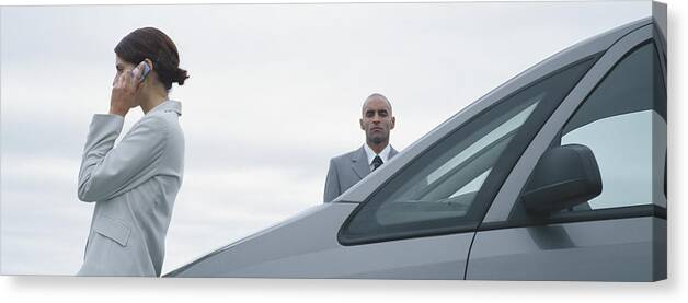 Bodyguard Canvas Print featuring the photograph Woman and man in suits standing near car, man looking at camera, woman talking on cell phone by Matthieu Spohn