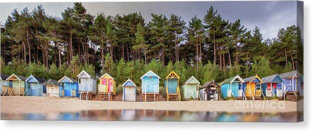 Wells Canvas Print featuring the photograph Beach hut row on the Norfolk coast by Simon Bratt
