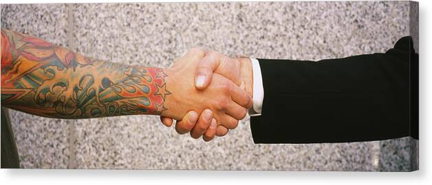 Photography Canvas Print featuring the photograph Close-up Of Two Men Shaking Hands #1 by Panoramic Images