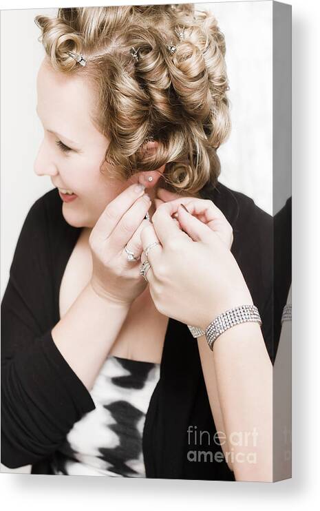Woman Canvas Print featuring the photograph Beautiful happy bride putting on earrings #1 by Jorgo Photography