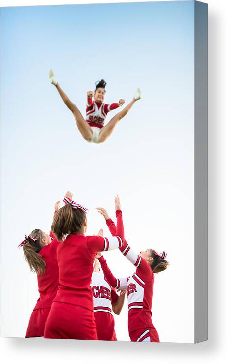 Human Arm Canvas Print featuring the photograph Cheerleaders throw up a girl in the air #2 by Franckreporter