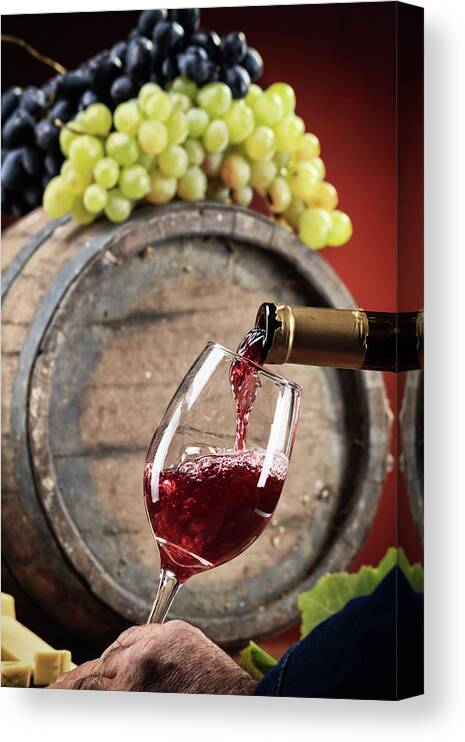 Alcohol Canvas Print featuring the photograph Red Wine Poured Into Glas #2 by Valentinrussanov