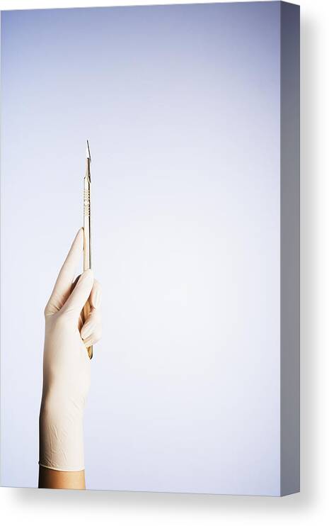 Expertise Canvas Print featuring the photograph A gloved hand holding a scalpel by Martin Barraud