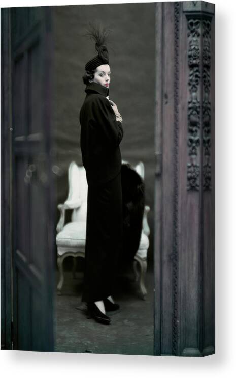 Fashion Canvas Print featuring the photograph A Model Wearing An Adele Simpsons Ensemble by John Rawlings