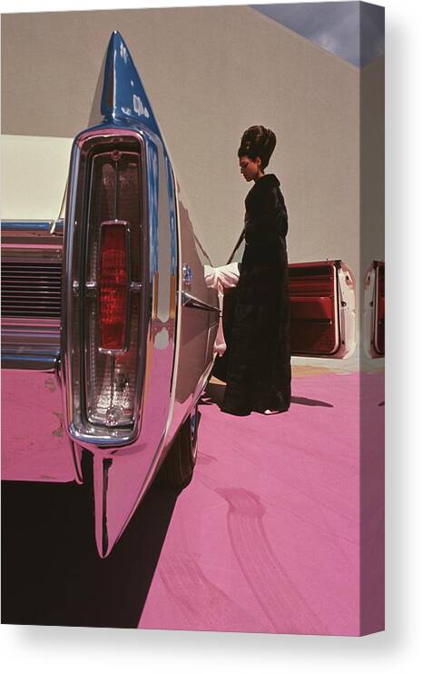 Auto Canvas Print featuring the photograph A Model Wearing Emeric Partos Entering A 1965 by Gene Laurents