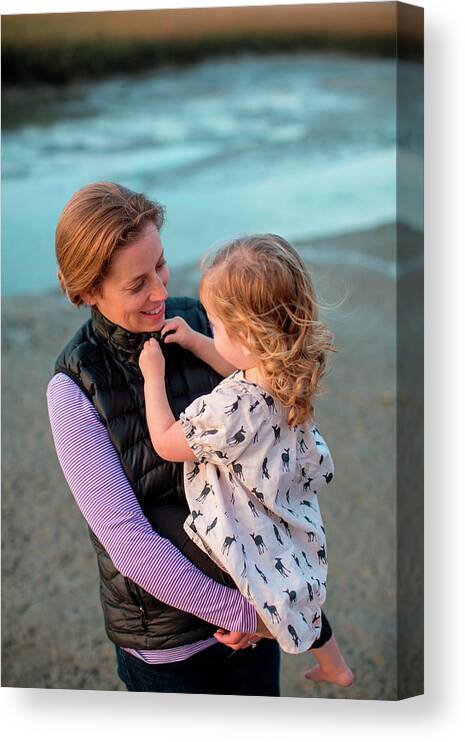 Wrightsville Beach Canvas Print featuring the photograph A Woman Carrying Her Daughter by Logan Mock-Bunting