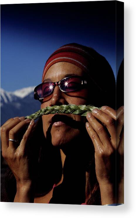 Breath Canvas Print featuring the photograph A Woman Smells A Piece Of Sage by Dawn Kish