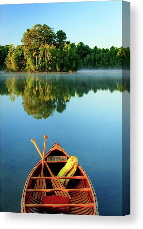 Scenics Canvas Print featuring the photograph An Old Wooden Canoe On Calm Lake by Tom Whitney Photography